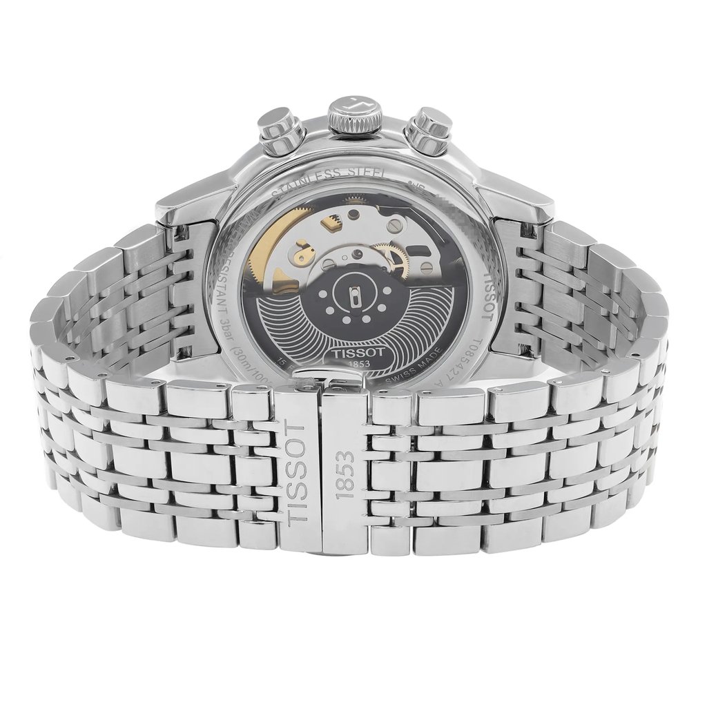 An image of a Wristwatch by Tissot. This Display Model item is designed for Men, featuring a Casual style. It has a Mechanical (Automatic) movement and an Analog display with a White dial color. The indices include 12-Hour Dial,Stick Indexes. The band is made of Stainless Steel and the case is made of Stainless Steel. The watch has a Round shape with a case size of 42 mm and a case thickness of 14 mm.