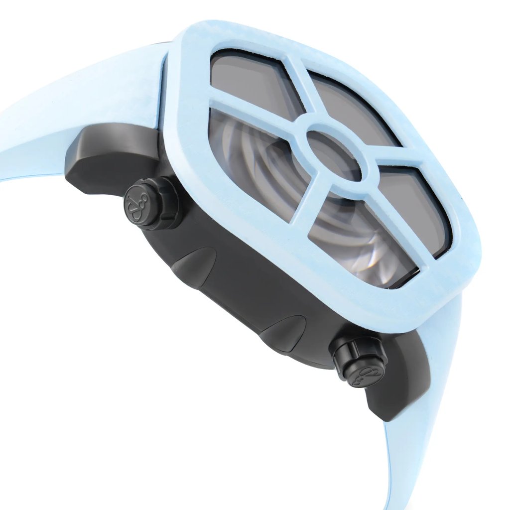 An image of an unworn JACOB & Co. luxury men's wristwatch in a side profile view opposite of the main crown, showcasing a distinctive pentagon-shaped case made of stainless steel with a black dial. The bezel is blue, and the band is made of blue rubber. The watch is positioned at a slight angle, with the side closer to the viewer appearing larger, emphasizing the watch's design and shape. The image is taken from a close distance, providing a clear view of the watch's side details, including the pushers on the case.