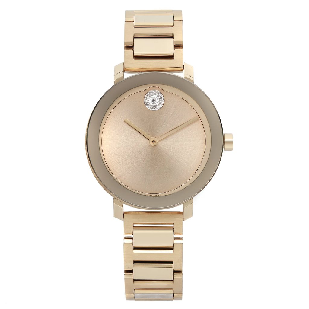 An image of a pre-owned wristwatch captured from a front full-frontal view. The watch features a gold-toned bracelet and a minimalist dial with a single crystal accent at the 12 o'clock position. The image is taken at a close distance, highlighting the watch's sleek design and subtle details.