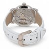 An image of a pre-owned Audemars Piguet women's wristwatch, viewed from the back at a slight angle. The focus is on the transparent case back, showcasing the intricate mechanical movement inside. The watch features a white leather strap with visible stitching, and the metal buckle is prominently displayed in the foreground.