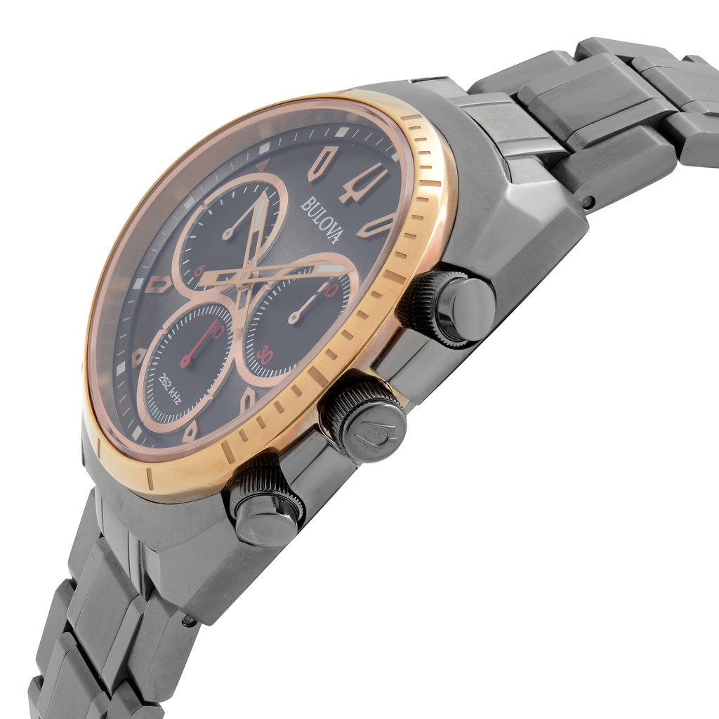 An image of a pre-owned Bulova men's wristwatch in a side profile view focusing on the crown. The watch features a round stainless steel case with a rose gold-tone bezel and a gray dial. The dial includes chronograph features, luminous hands, and a small seconds subdial. The stainless steel band is visible extending to the left side of the frame. The image is taken from a close distance, accentuating the watch's side profile and the crown's details.