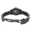 An image of a wristwatch showing the back view with an open clasp. The watch is positioned horizontally, showcasing the internal mechanism through a transparent case back. The black ceramic bracelet is partially extended, revealing the titanium clasp. The photograph is taken from a slight angle above and at a close distance, highlighting the details of the display model's back side.