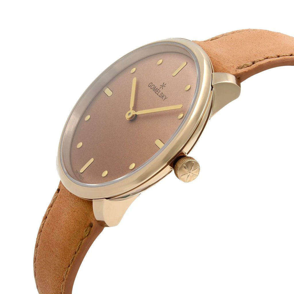 An image of a wristwatch in an unworn condition, shown from a side profile view with the crown visible. The watch features a gold-toned case and a brown dial with minimalistic hour markers and hands. The strap is made of light brown leather. The angle highlights the watch's elegant design, focusing on the crown and the seamless integration of the strap with the case.