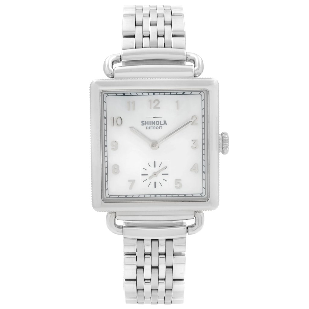 An image of a Wristwatch by Shinola. This Pre Owned item is designed for Women, featuring a Dress/Formal style. It has a Quartz movement and an Analog display with a White dial color. The indices include 12-Hour Dial,Arabic Numerals,Multi Dial. The band is made of Stainless Steel and the case is made of Stainless Steel. The watch has a Square shape with a case size of 28 mm and a case thickness of 8.5 mm.