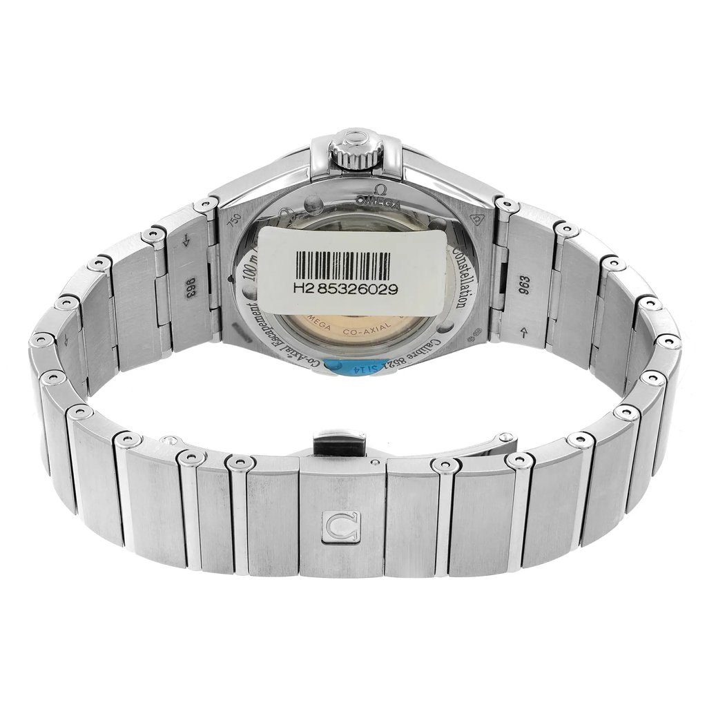 An image of a women's OMEGA wristwatch in display model condition, featuring a white gold case and band with an exhibition caseback. The view is from the back, showing the closed clasp and the watch positioned at a direct angle with the camera, capturing the entire circumference of the band and the back case in the frame from a close distance. The watch shape is round, and the OMEGA logo is visible on the clasp and caseback.