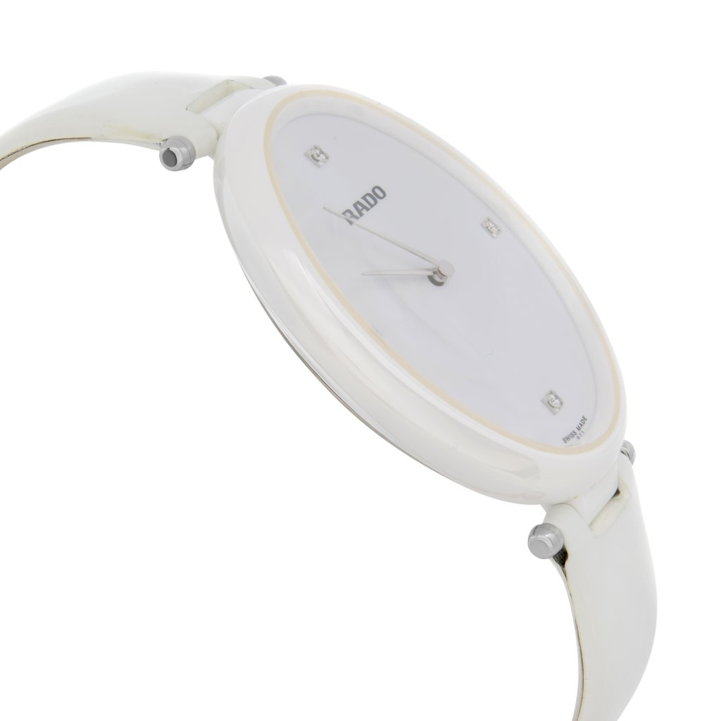 An image of a wristwatch from a side profile view, showing the opposite side of the crown. The watch is positioned at an angle, slightly tilted, and is photographed from a close distance. The watch has a smooth, white finish and appears new with some defects visible. The face is minimalistic with sleek hands and subtle markers.