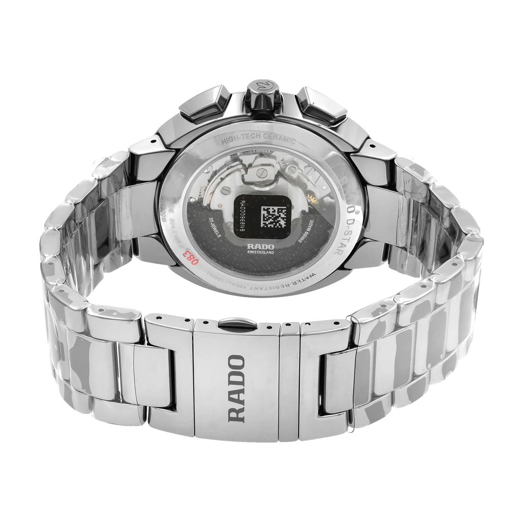 An image of a new wristwatch displaying the back view of the watch. The watch is positioned at a slight angle, showcasing the closed clasp and the intricate details of the back case. The silver metallic bracelet is prominently featured, with the brand name visible on the clasp. The image is taken from a close distance, allowing a clear view of the craftsmanship and materials used in the watch.