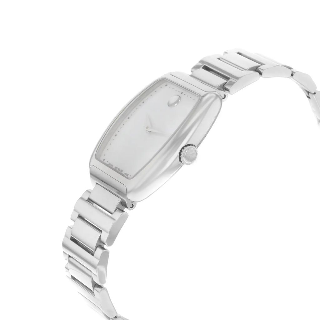 An image of a pre-owned wristwatch viewed from a side profile angle, highlighting the crown. The watch features a sleek, metallic band and a minimalist face with a single dot at the 12 o'clock position. The angle accentuates the watch's curved, rectangular case, and the image is taken at a close distance to capture the details of the design.