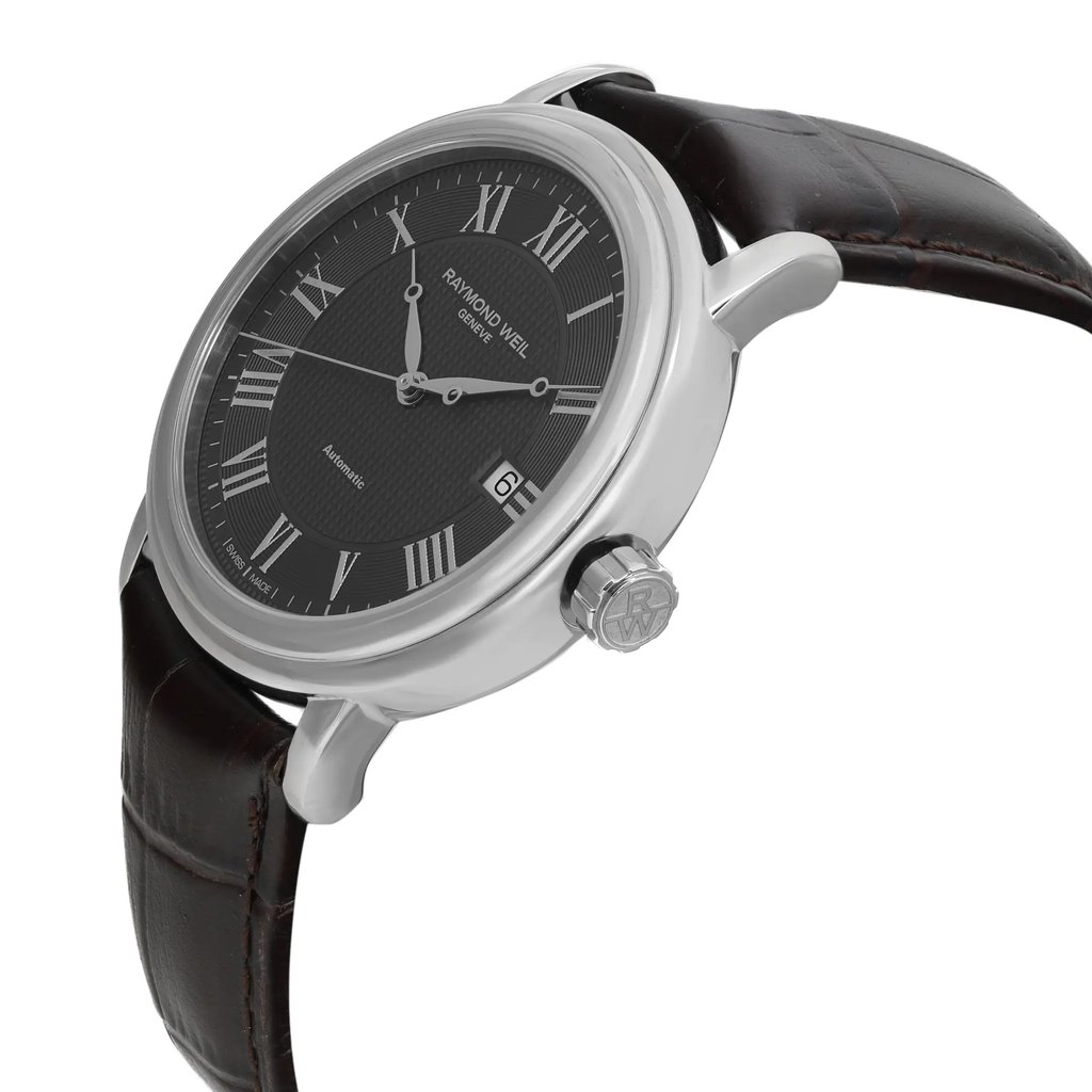 An image of a Wristwatch by RAYMOND WEIL. This Display Model item is designed for Men, featuring a Casual style. It has a Mechanical (Automatic) movement and an Analog display with a Gray dial color. The indices include 12-Hour Dial,Roman Numerals. The band is made of Leather and the case is made of Stainless Steel. The watch has a Round shape with a case size of 39 mm and a case thickness of 9.5 mm.