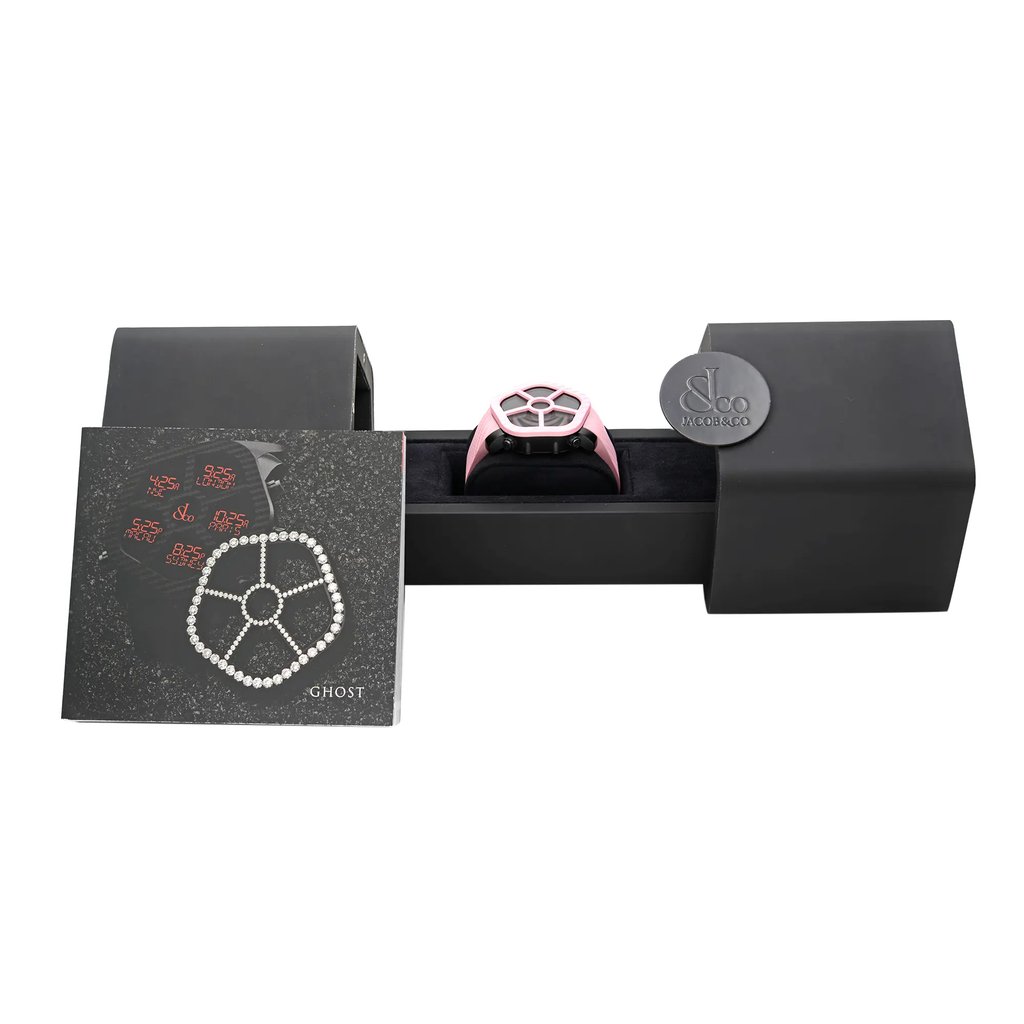 An image of a wristwatch displayed in its open box, positioned centrally. The watch is angled slightly forward, showcasing its unique design, and is surrounded by its packaging and documents. The box and documents are placed parallel to the camera, filling the frame from a medium distance. The watch's face features a distinct pattern, and the band is visible, highlighting its display model condition.