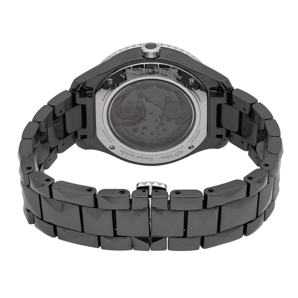 An image of a wristwatch showing the back view with a close-up of the clasp. The watch is positioned centrally, displaying its polished metal links and transparent case back, revealing the intricate inner mechanisms. The angle highlights the craftsmanship of the bracelet and the watch's mechanical components. The watch is a display model.