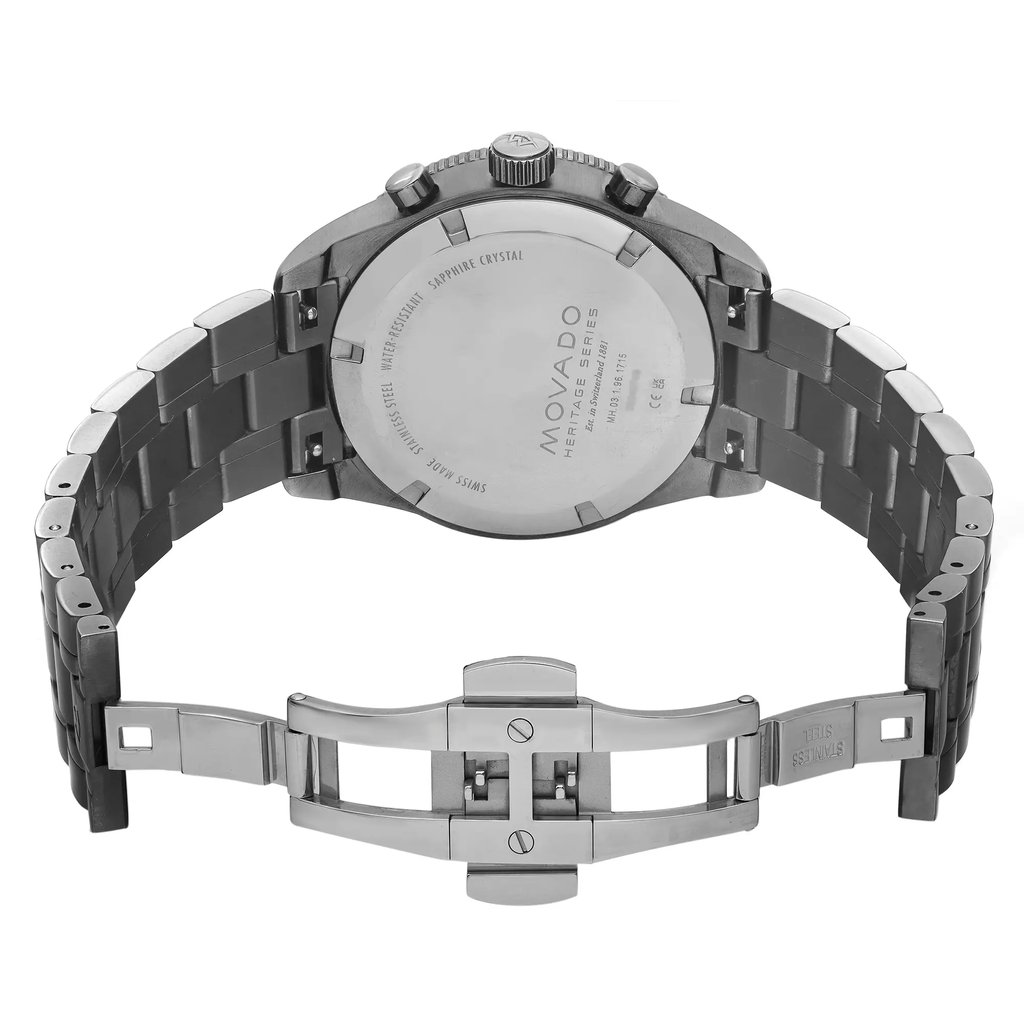 An image of a pre-owned wristwatch showing the back view with an open clasp. The watch is positioned upright, highlighting the stainless steel back and the bracelet links. The angle is straight-on, providing a clear view of the inscriptions on the watch back, including the brand name. The distance is close, focusing on the details of the open clasp mechanism and the polished metal finish.