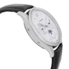 An image of a pre-owned Montblanc luxury men's wristwatch, displayed in a side profile view opposite the crown, emphasizing the watch's round shape and stainless steel case. The watch features a white dial with gray bezel, luminous hands, and complications such as day/date, GMT, and moon phase. It is attached to a black leather band. The photo is taken at a close distance, showcasing the timepiece at an angle that reveals slight imperfections on the hands and dial.