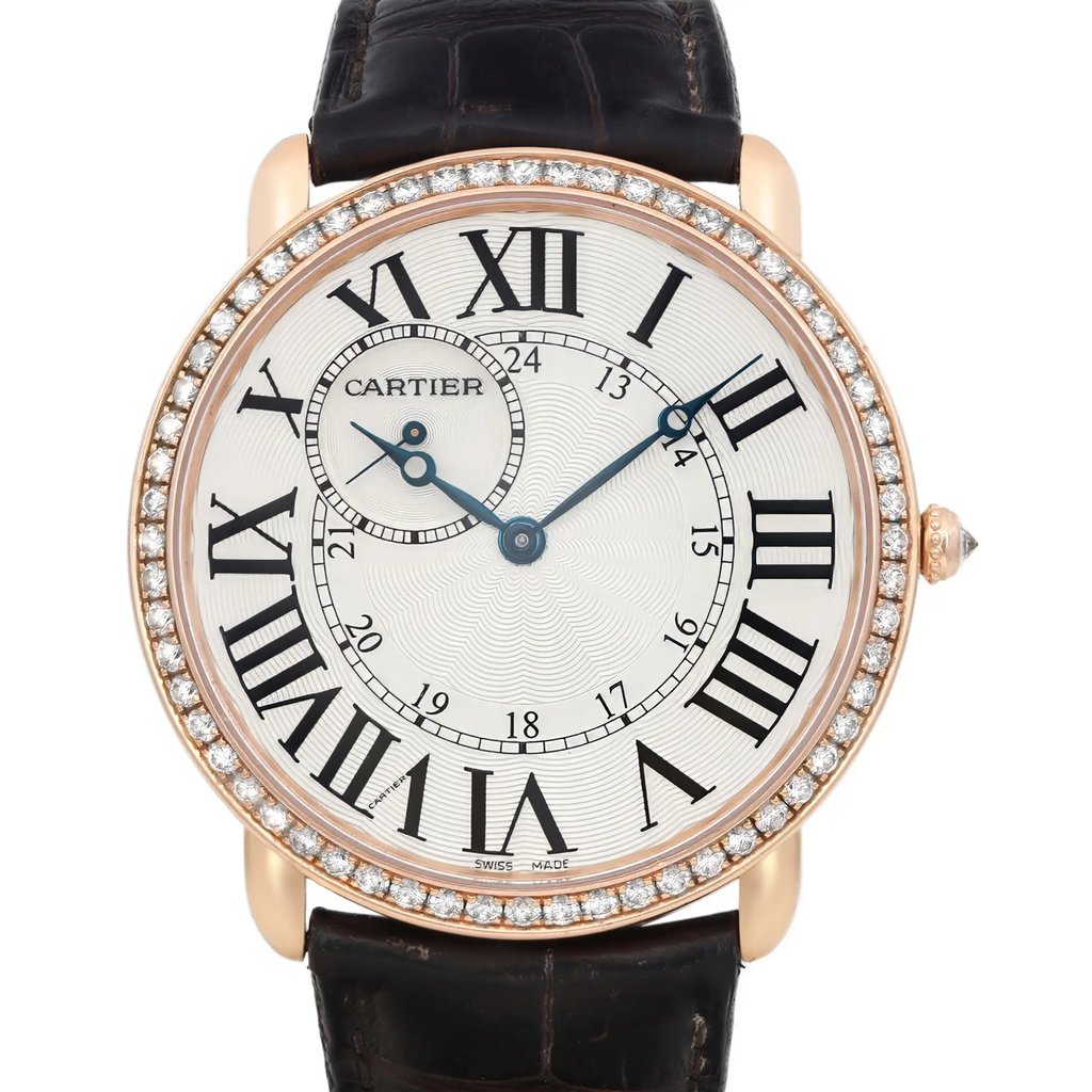 An image of a pre-owned wristwatch captured in a front close-up shot, highlighting the watch face. The watch features a round dial with large Roman numerals, blue hands, and a smaller subdial. The bezel is adorned with a ring of small diamonds, and the strap is made of dark leather. The angle and distance emphasize the intricate details of the watch face and embellishments.