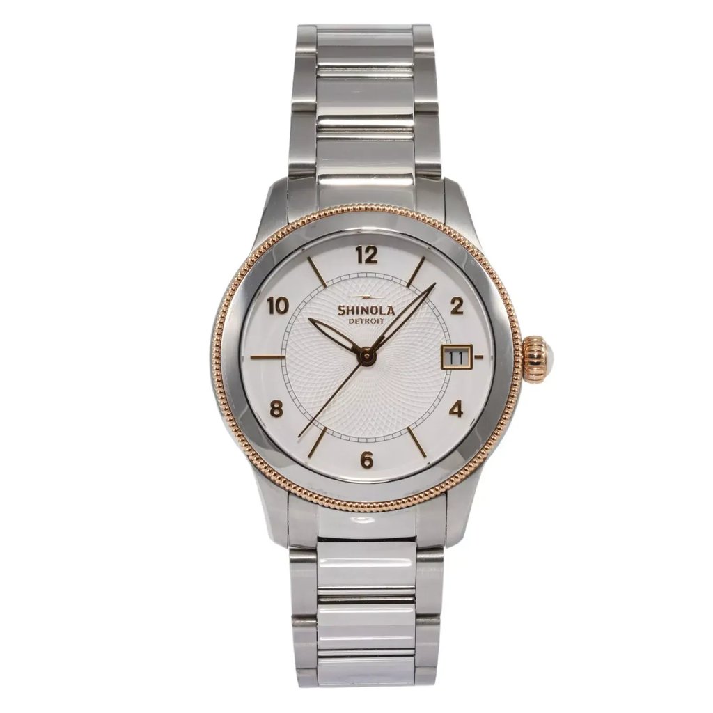 An image of a pre-owned wristwatch viewed from a front full frontal angle. The watch features a silver metal band and a round face with a white dial. It has black numerals and hands, with a date window positioned at the 3 o'clock mark. The watch is centered in the image, photographed at a close distance.