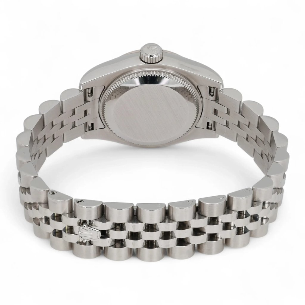 An image of a pre-owned Rolex women's wristwatch viewed from the back. The watch is positioned horizontally with the watch face angled away, showcasing the stainless steel case and bracelet. The angle highlights the smooth, round back of the watch and the detailed links of the bracelet. The image is taken at a close distance, emphasizing the craftsmanship and condition of the watch.