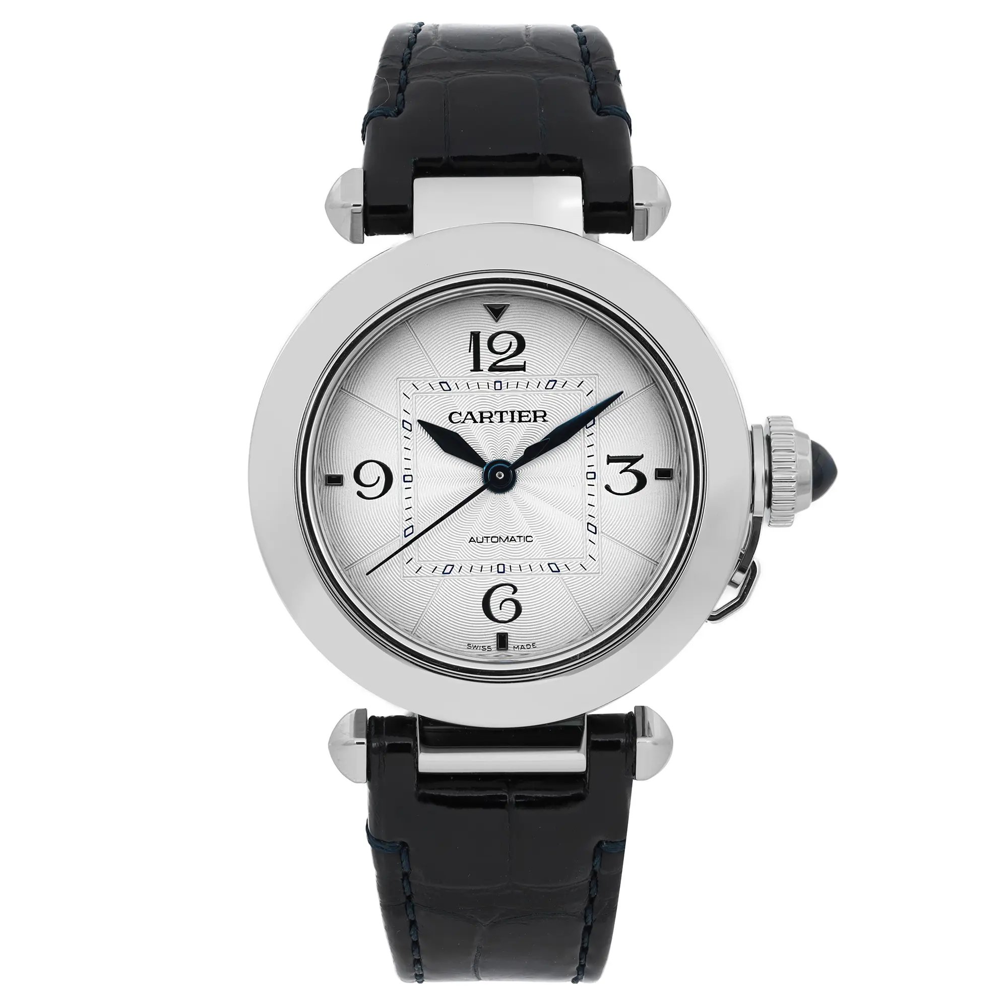 An image of a pre-owned Cartier Pasha Steel men's 35mm silver dial automatic wristwatch, captured from a straight-on angle, showcasing the watch face prominently. The watch features a circular silver dial with black numerals and a black leather strap. The crown is visible on the right side, detailed with a blue cabochon. The photo is taken at a close distance, highlighting the elegant design and details of the watch.