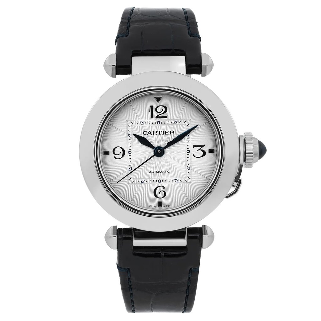 An image of a pre-owned Cartier Pasha Steel men's 35mm silver dial automatic wristwatch, captured from a straight-on angle, showcasing the watch face prominently. The watch features a circular silver dial with black numerals and a black leather strap. The crown is visible on the right side, detailed with a blue cabochon. The photo is taken at a close distance, highlighting the elegant design and details of the watch.