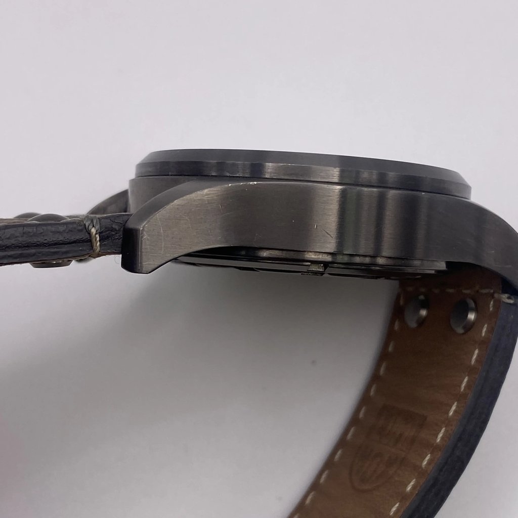 View of opposite crown facing side of the stainless steel case with a dents and scratches on it