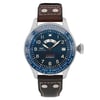 An image of a pre-owned IWC Timezoner Le Petit Prince Edition men's wristwatch positioned upright and facing forward. The watch features a round, blue dial with luminous hands, displaying multiple time zones around the bezel. It has a brown leather strap with visible stitching and metal rivets. The watch is captured at a close-up angle, showcasing the intricate details of its design and functionality.