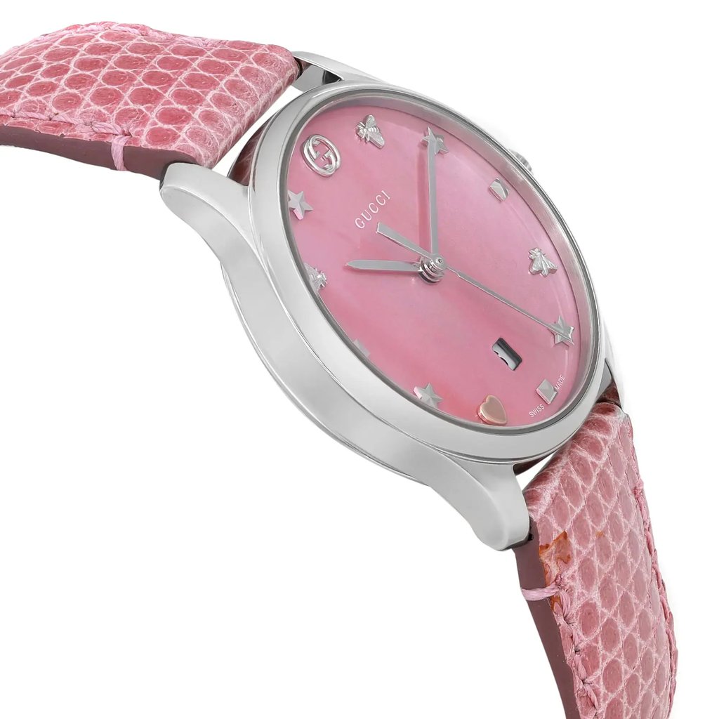 An image of a Wristwatch by Gucci. This Unworn item is designed for Women, featuring a Casual style. It has a Quartz movement and an Analog display with a Pink dial color. The indices include 12-Hour Dial,Non-Numeric Hour Marks. The band is made of Leather and the case is made of Stainless Steel. The watch has a Round shape with a case size of 29 mm and a case thickness of 8 mm.