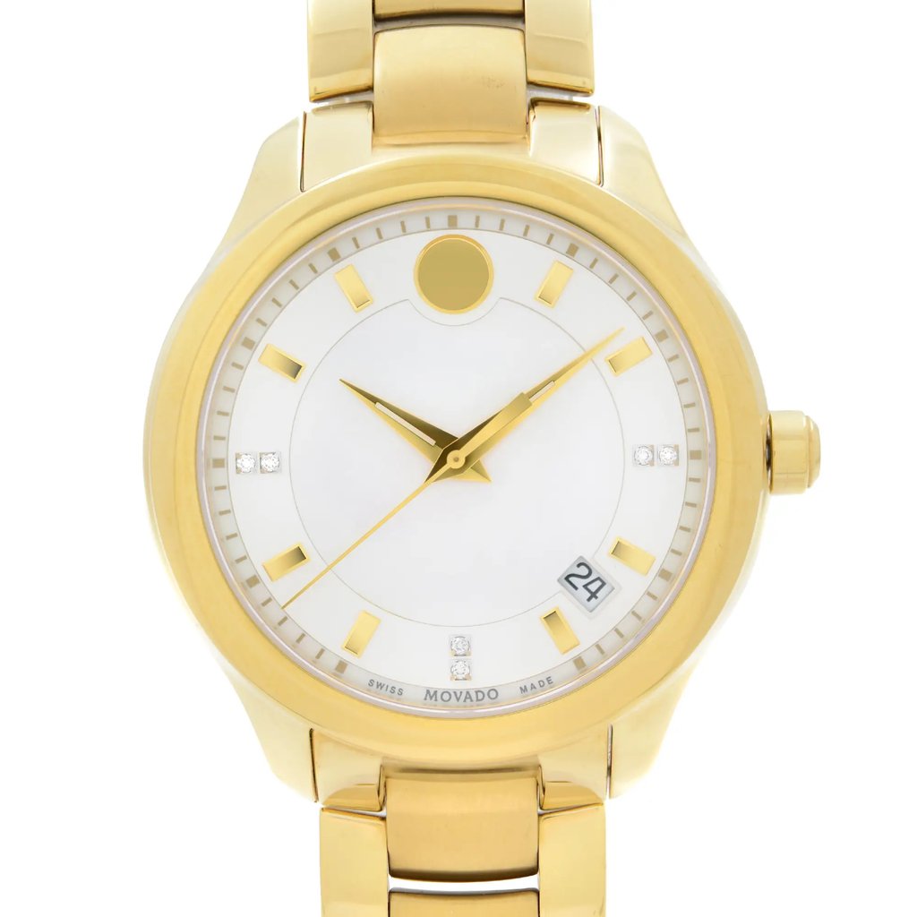 An image of a pre-owned wristwatch taken from a front close-up angle, focusing on the watch face. The watch features a gold-tone case and bracelet, with a clean white dial. It has gold hour markers and hands, along with small diamond accents at the 3 and 9 o'clock positions. The date is displayed at the 4 o'clock position. The overall appearance is elegant and luxurious.