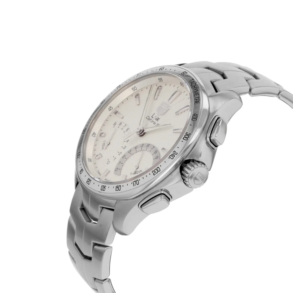 An image of a pre-owned TAG Heuer men's sport wristwatch in a side profile view. The stainless steel case and band are prominently displayed, with the crown and chronograph buttons clearly visible. The round watch has a silver dial featuring luminous hands. The angle highlights the watch's sleek design and craftsmanship.