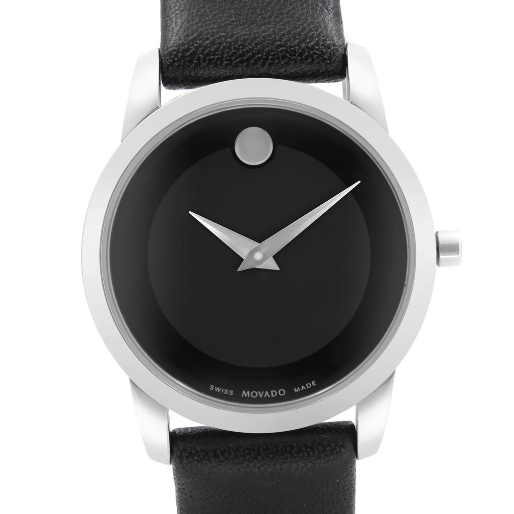 An image of a pre-owned wristwatch taken from a front close-up angle, showcasing the watch face. The watch features a minimalist design with a black dial and a single dot at the 12 o'clock position. The hands are silver, and the casing is sleek and metallic. The black leather strap is partly visible at the top and bottom of the image.