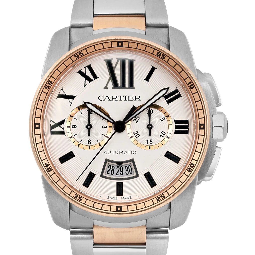 An image of a pre-owned Cartier men's wristwatch, viewed from the front at a close distance. The watch features a steel and rose gold-tone case with a chronograph and date indicator. The dial has Roman numerals, luminous hands, and two sub-dials. The bracelet is a combination of stainless steel and rose gold links.