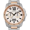 An image of a pre-owned Cartier men's wristwatch, viewed from the front at a close distance. The watch features a steel and rose gold-tone case with a chronograph and date indicator. The dial has Roman numerals, luminous hands, and two sub-dials. The bracelet is a combination of stainless steel and rose gold links.