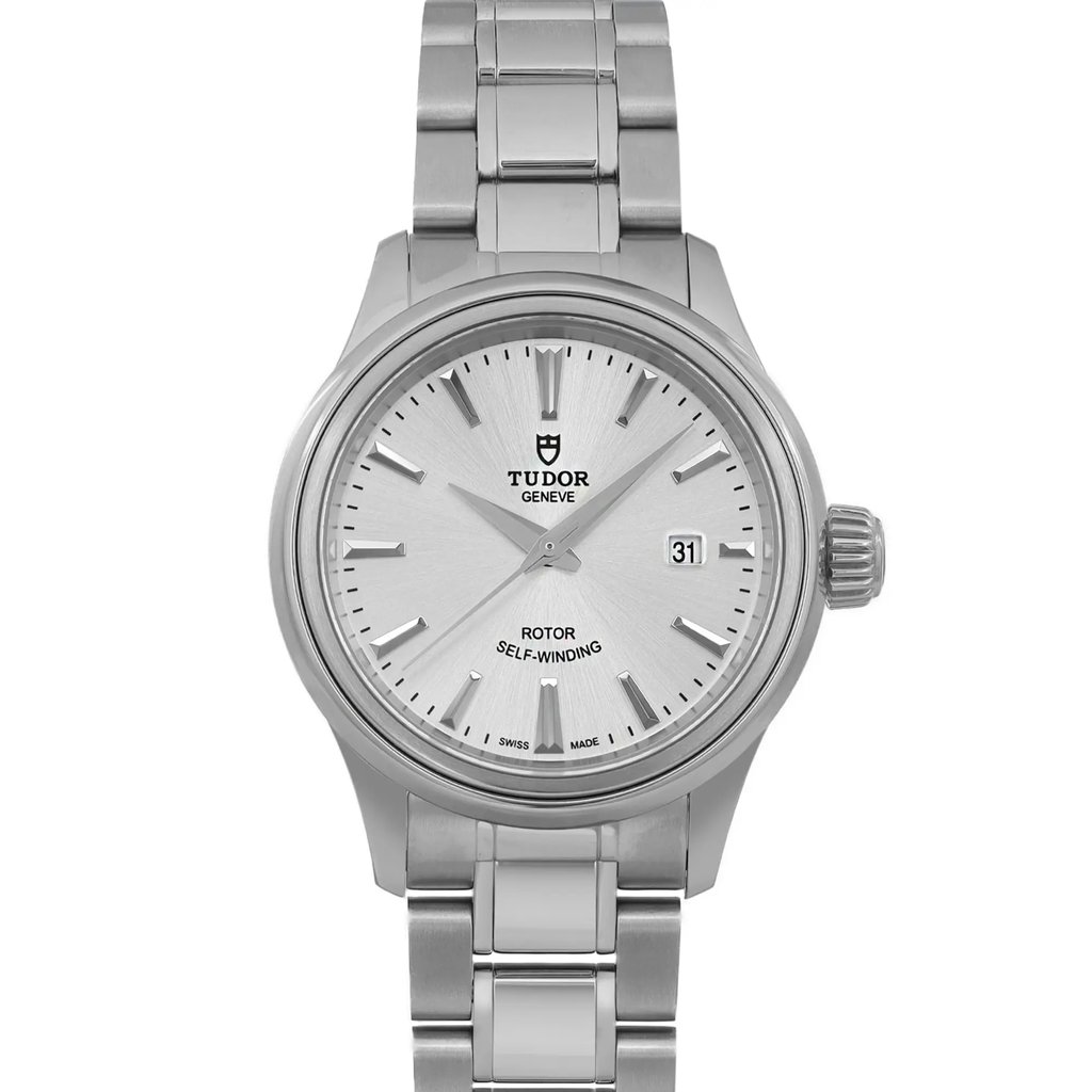 An image of an unworn wristwatch taken from a front close-up angle, highlighting the watch face. The timepiece features a sleek metal bracelet and a detailed watch face with a date display on the right side. The branding is visible below the 12 o'clock position.