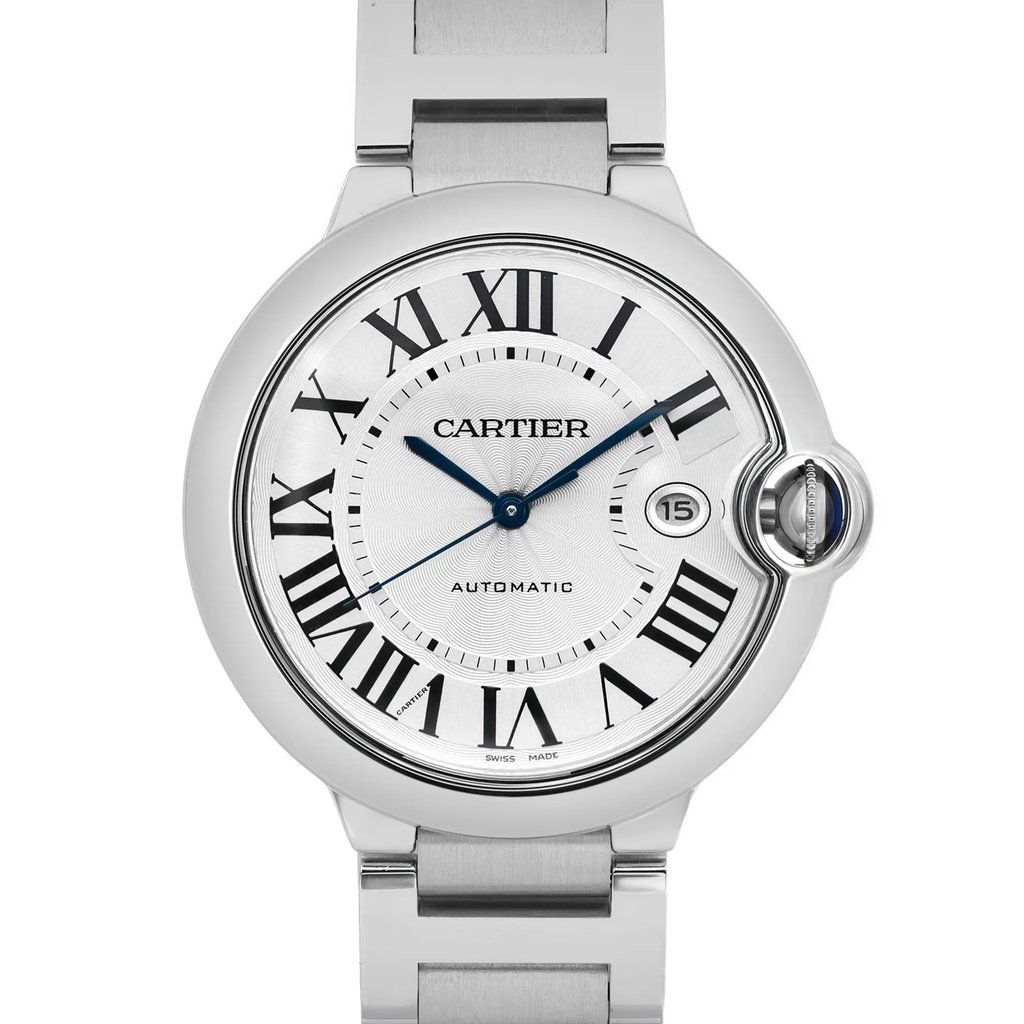 An image of a pre-owned wristwatch, captured in a front close-up shot focusing on the watch face. The watch features a classic design with Roman numerals and a date window. The metallic strap and casing highlight its elegant style. The brand name is visible on the face, and the watch hands are positioned centrally.