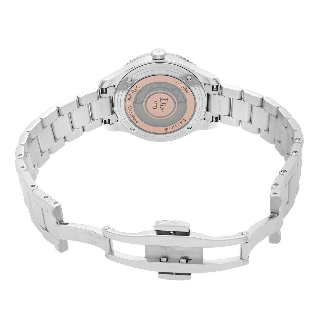 An image of a women's Dior wristwatch viewed from the back, showcasing the open clasp. The watch features a stainless steel band and case, with an exhibition caseback. The round watch is positioned at a slight angle, highlighting the intricate details of the clasp and the brand's engraving. The watch is a display model in excellent condition, captured from a close distance.