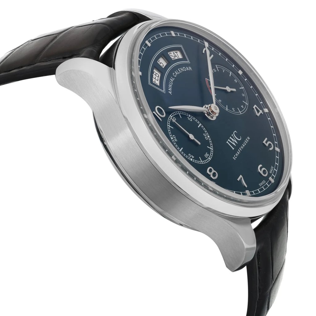 An image of a pre-owned wristwatch shown from the side profile view, opposite the crown. The watch features a sleek metal case and a dark leather strap. Its dark dial includes a day, date, and month display along with two subdials, viewed from a slightly elevated angle and close distance to highlight the watch's details.