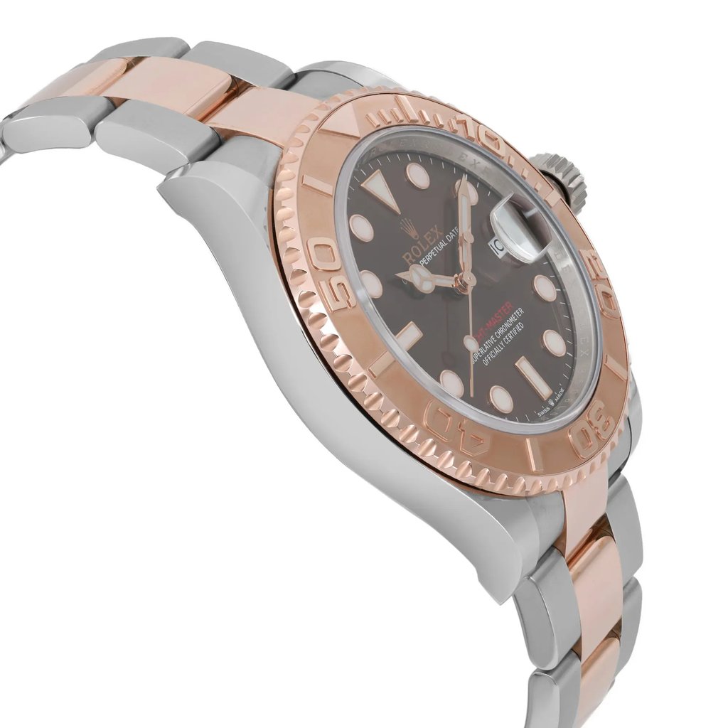 An image of a pre-owned wristwatch captured from a side profile view, opposite the crown. The watch features a two-tone metal bracelet with rose gold and silver links. The angle highlights the rose gold bezel and the dark dial with luminous markers and hands. The photograph is taken at a close distance, showcasing the intricate design details of the watch.