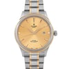 An image of a wristwatch featuring a close-up, front-facing view of the watch face. The watch has a gold-toned dial with slim hour markers and hands, accompanied by a date display at the 3 o'clock position. The case and bracelet are two-toned, combining silver and gold elements. The watch is in unworn condition, highlighting its pristine appearance.