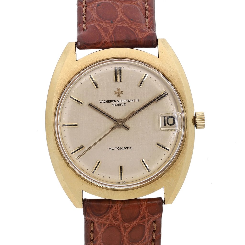 An image of a pre-owned wristwatch shown in a front close-up shot of the watch face. The watch has a gold-toned bezel and a light-colored dial with simple hour markers and hands. A date window is visible at the 3 o'clock position. The watch is attached to a brown leather strap with a textured pattern. The image captures the watch from a straight-on angle, highlighting its elegant design and details.