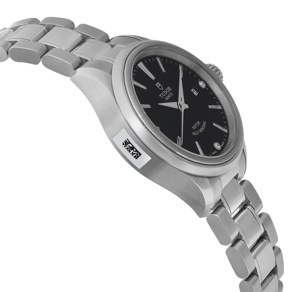 An image of a wristwatch from a side profile view, opposite the crown. The watch is unworn and features a sleek metal bracelet and a polished case. The angle highlights the watch face partly, showcasing its dark dial and subtle markers. The focus is on the side of the watch, with a QR code sticker visible on the case. The image is taken at a close distance, emphasizing the watch's design and craftsmanship.