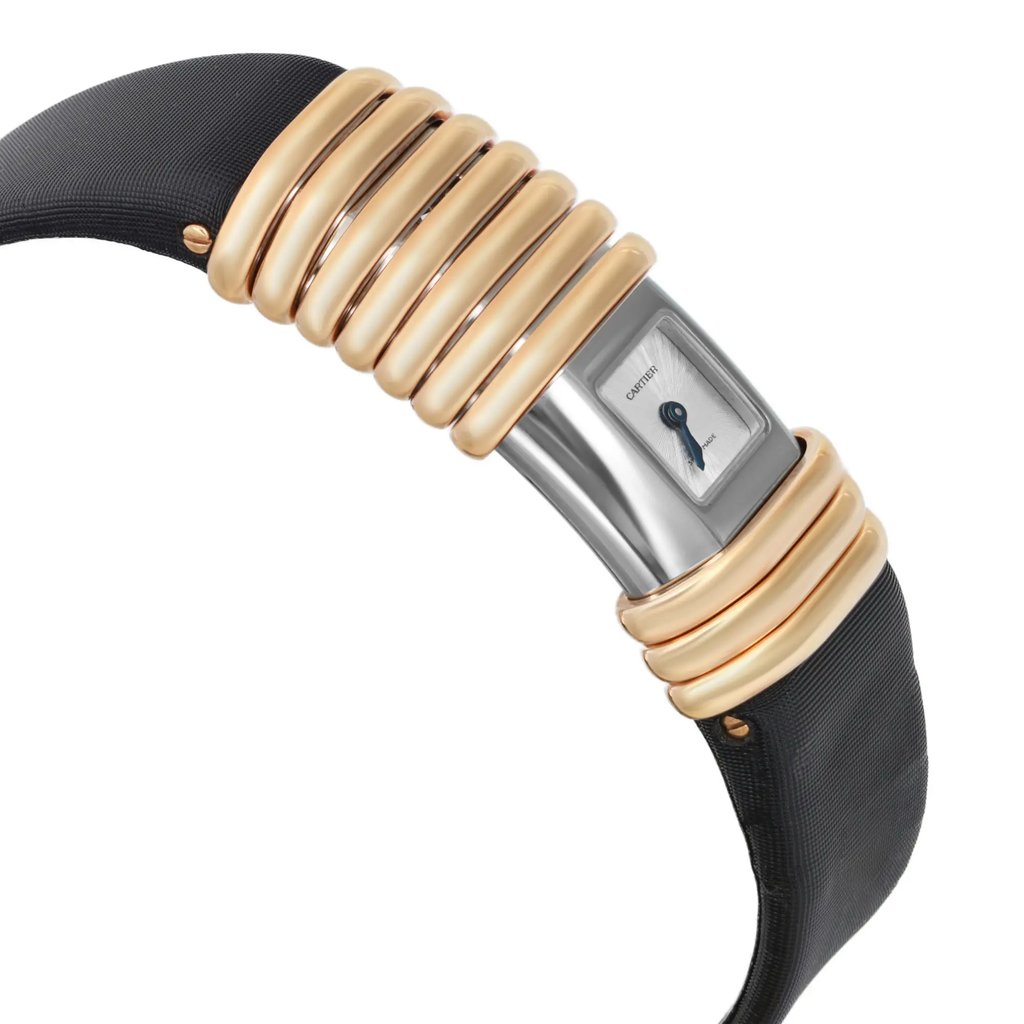 An image of a pre-owned wristwatch shown from a side profile view, opposite the crown. The watch features a sleek design with a metal case and distinctive gold-toned, ribbed segments on the band. The dial displays minimalistic details, positioned at a slight angle, highlighting its elegant craftsmanship. The image is taken at a close distance, emphasizing the watch's unique styling and materials.