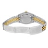 An image of a pre-owned men's Rolex wristwatch, viewed from the back with an open clasp. The case is made of stainless steel with a solid caseback, and the band is a combination of stainless steel and yellow gold. The watch is positioned at a slight angle, showcasing the fold-over clasp and the round shape of the case. The focus is on the intricate details of the band and clasp, captured from a moderate distance.