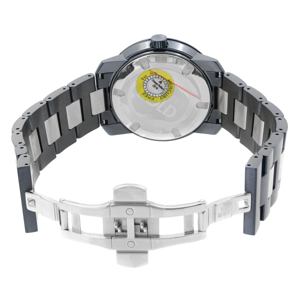 An image of a wristwatch taken from the back view, featuring an open clasp. The watch is positioned at a slightly elevated angle, showcasing the stainless steel bracelet and the transparent case back. The clasp is prominently displayed in the foreground at a close distance, highlighting the new condition with visible defects.