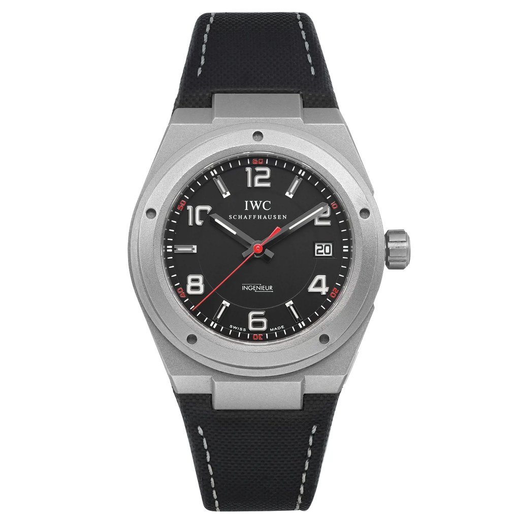 An image of a pre-owned wristwatch displayed from a front full frontal view. The watch features a black dial with white and red accents, a date display, and a silver case. The black strap has white stitching, and the watch is positioned centrally, showcasing its details clearly.