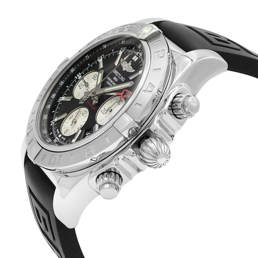 An image of a pre-owned Breitling men's luxury wristwatch, viewed from a side profile highlighting the crown. The watch features a round stainless steel case with a gray bezel, and a black dial, and is fitted with a black rubber band. The crown and pushers are prominently visible, and the watch is positioned at a slight angle to showcase its design, occupying the central portion of the frame. The watch shows minor signs of wear and scratches.