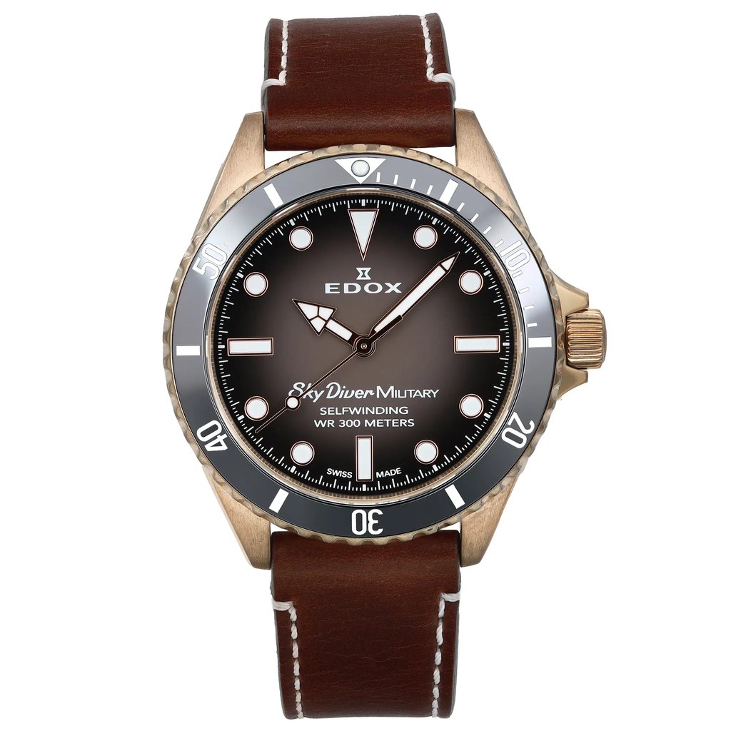 An image of a pre-owned wristwatch, shown from a front full frontal view. The watch has a brown leather strap and a bronze-toned case. The dial is dark with white markings and hands, and features the text "Sky Diver Military" and "300 Meters." The bezel is black with white numerals, positioned directly facing the viewer, showcasing its detailed design.