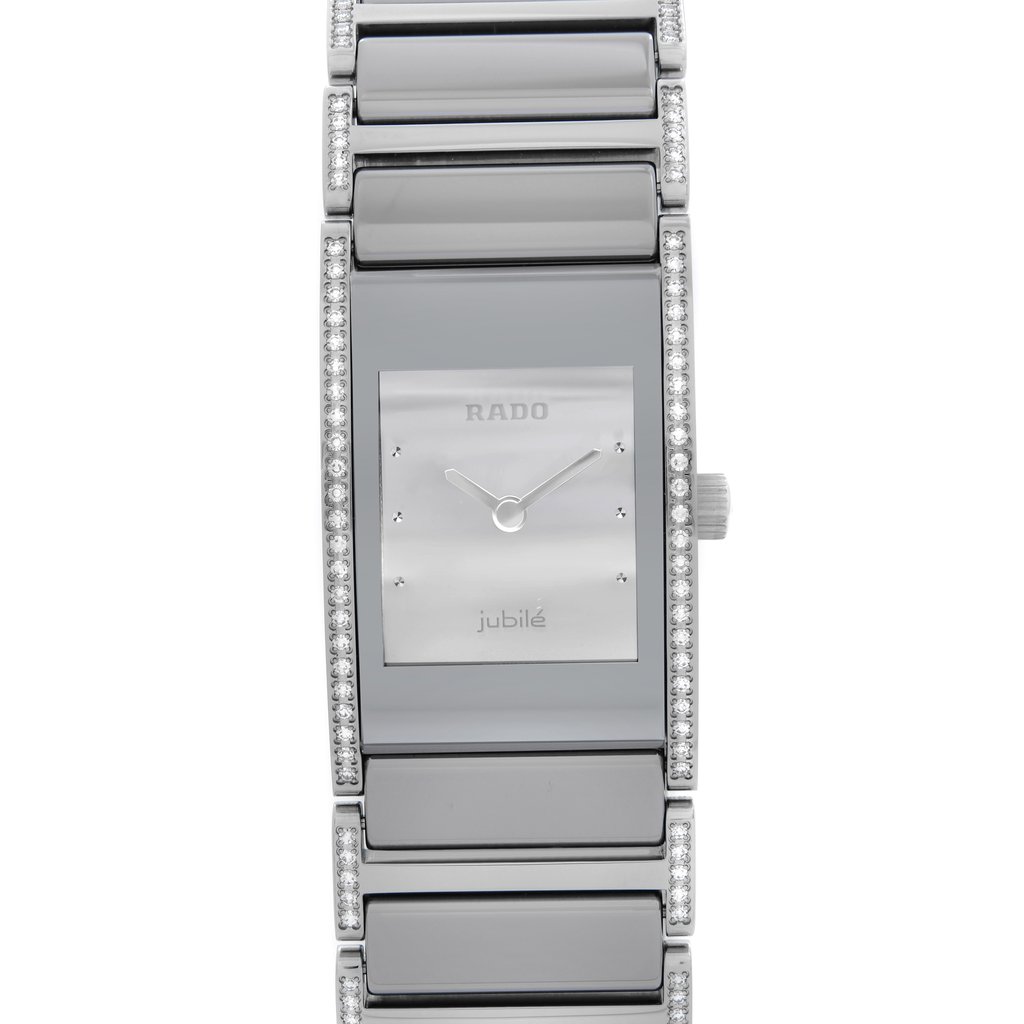 An image of a Wristwatch by Rado. This New With Defects item is designed for Women, featuring a Luxury style. It has a Quartz movement and an Analog display with a Silver dial color. The indices include Non-Numeric Hour Marks,Round Indexes. The band is made of Ceramic,Stainless Steel and the case is made of Ceramic,Stainless Steel. The watch has a Rectangle shape with a case size of 19 mm and a case thickness of 6 mm.