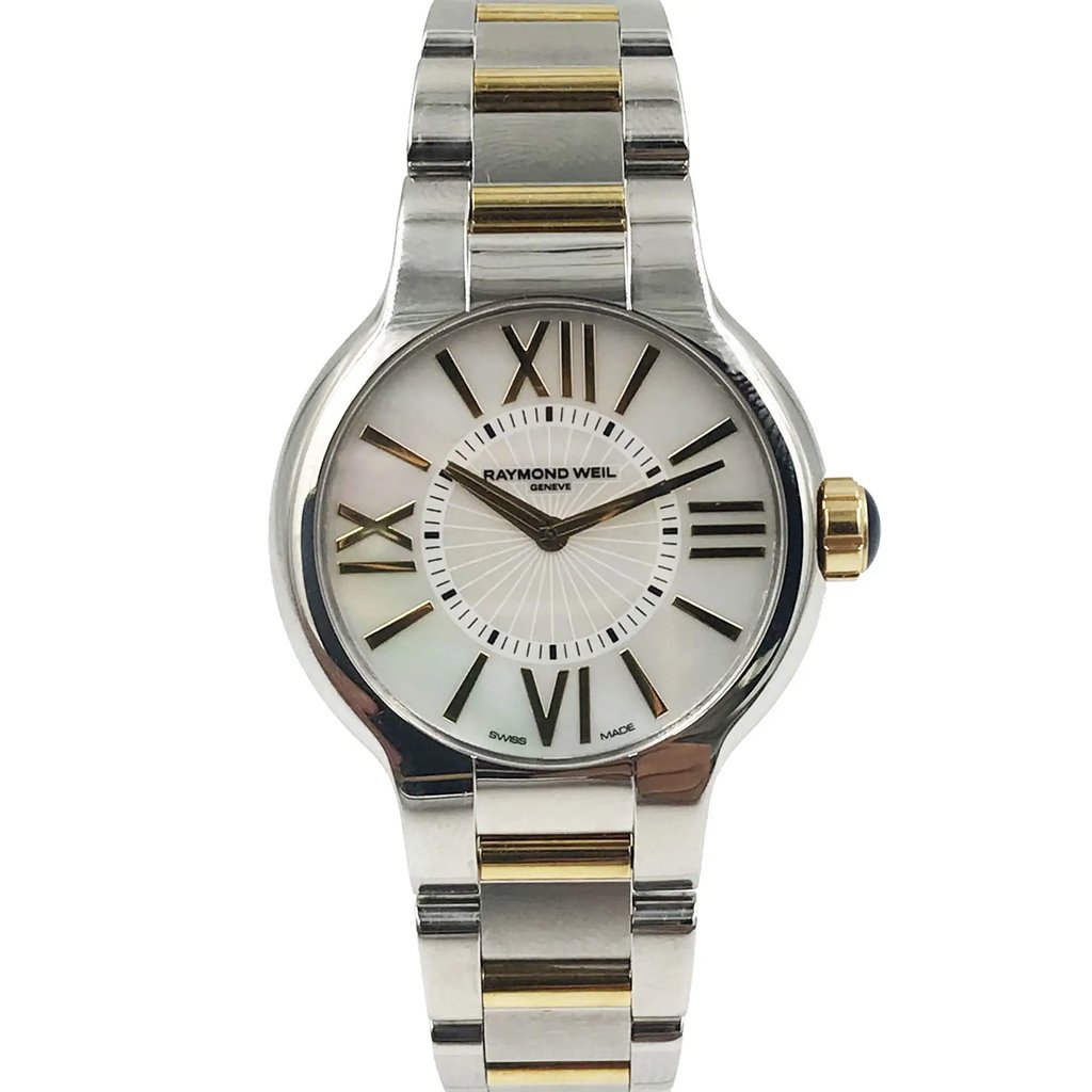 An image of a Wristwatch by RAYMOND WEIL. This Pre Owned item is designed for Women, featuring a Dress/Formal style. It has a Quartz movement and an Analog display with a Multicolor dial color. The indices include 12-Hour Dial,Roman Numerals,Stick Indexes. The band is made of Stainless Steel and the case is made of Stainless Steel. The watch has a Round shape with a case size of 32 mm and a case thickness of 6 mm.