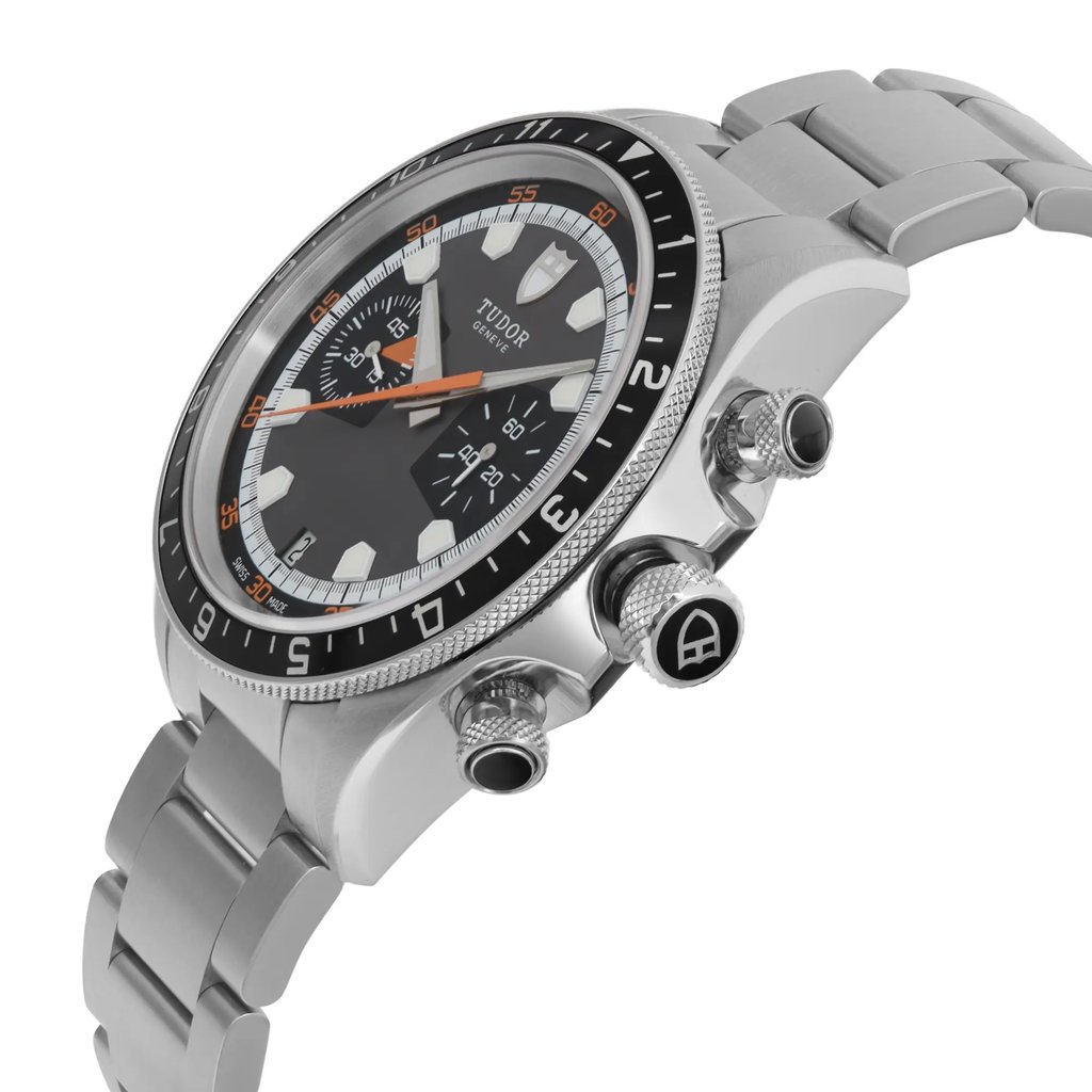 An image of a wristwatch viewed from a side profile, showcasing the crown. The watch features a silver metal bracelet and a detailed face with markings and subdials. The angle highlights the watch's textured crown and buttons, providing a close-up view of the display model's intricate design elements.