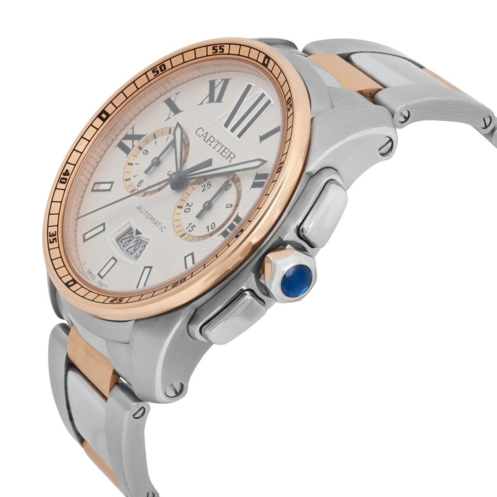 An image of a pre-owned Cartier men's wristwatch featuring a chronograph and date indicator. The watch has luminous hands and a round face, viewed at a slight angle from the right side. The steel and rose gold-toned bracelet and bezel are visible, along with a prominent blue crown on the side. The watch is positioned close-up, highlighting its elegant design and intricate details.