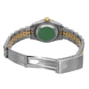 An image of a pre-owned wristwatch showing the back view with an open clasp. The watch is positioned horizontally, with the metal bracelet in focus. The two-tone band features silver and gold links, and the watch case back displays a prominent green circle. The image is taken from a slightly elevated angle at a close distance, highlighting the details of the bracelet and clasp.