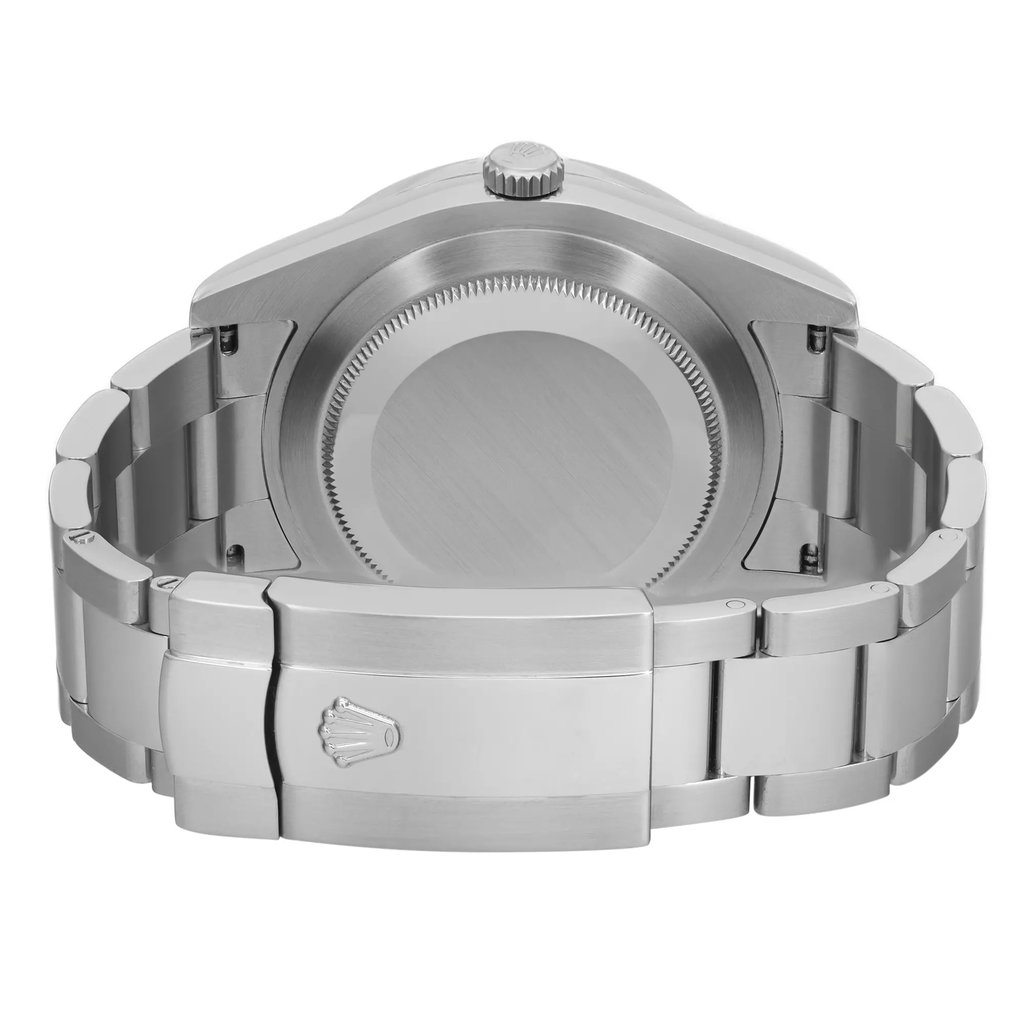 An image of a pre-owned wristwatch shown from the back view. The focus is on the closed clasp, which features a distinctive emblem. The watch is positioned centrally, capturing the metallic finish and the intricate details of the clasp and bracelet links. The angle is slightly elevated to emphasize the watch's craftsmanship, and the shot is taken from a close distance to highlight the texture and design.